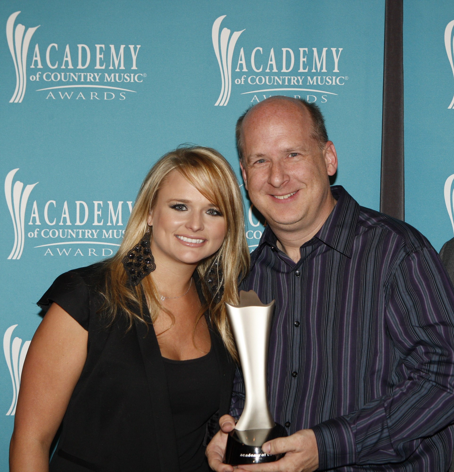 Buzz Jackson accepting an ACM Award from Miranda Lambert